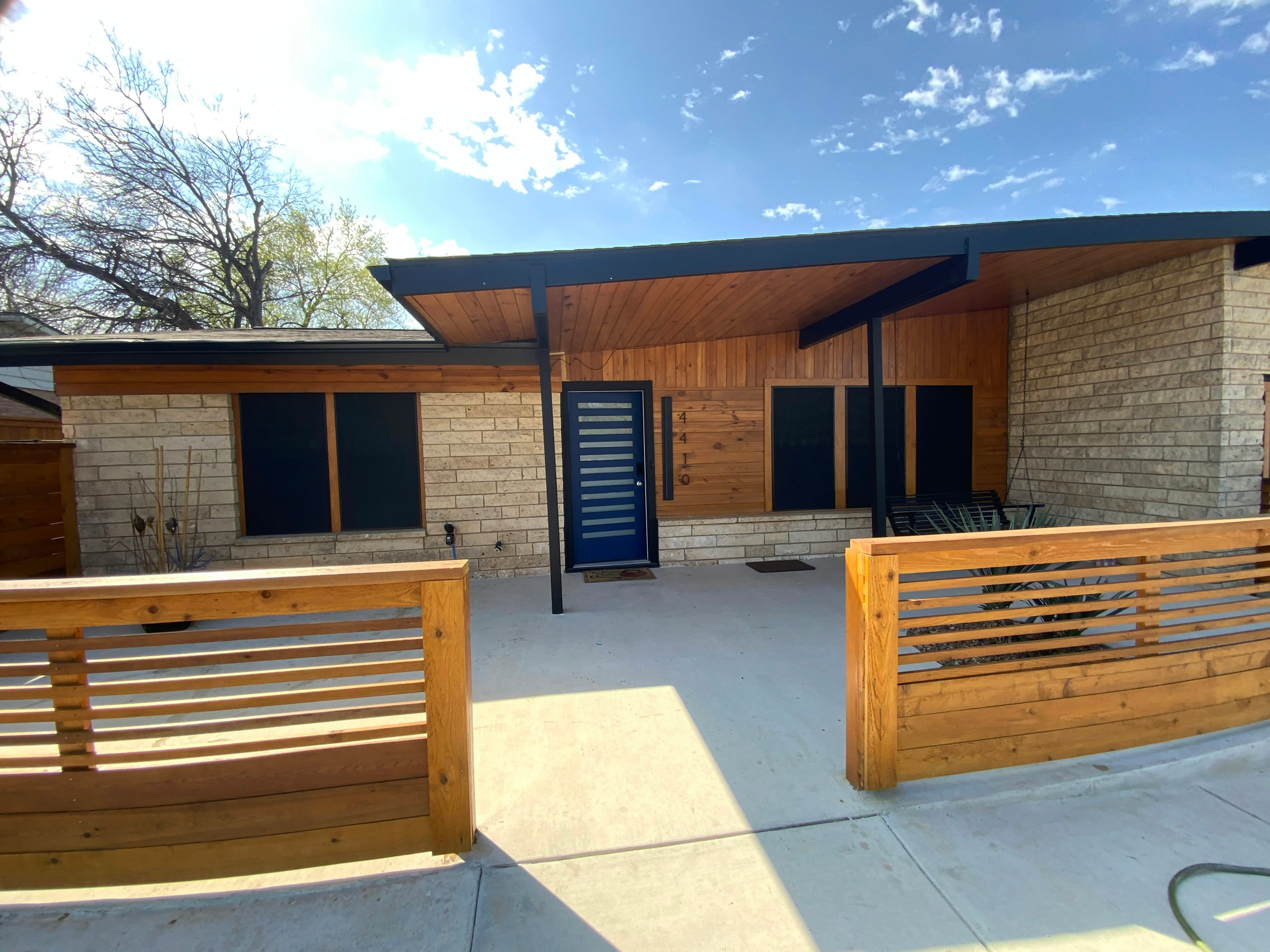 Outdoor living area featuring a custom deck and seating