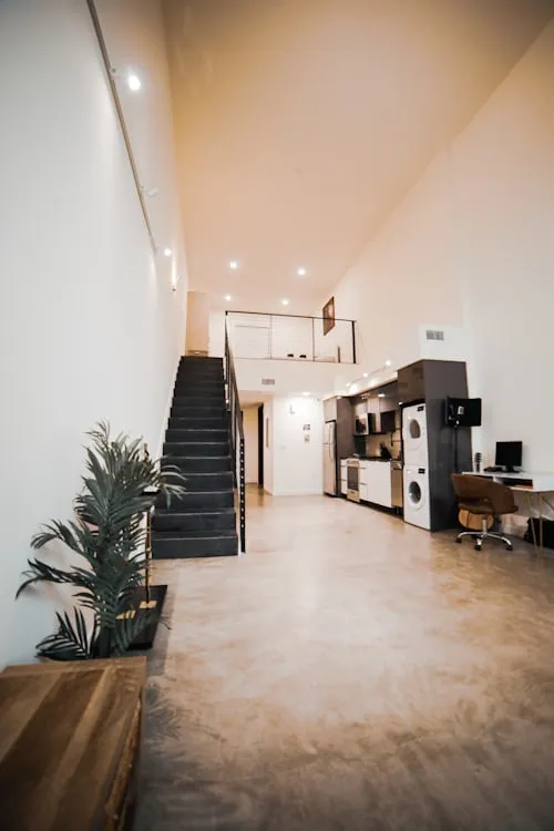 Minimalist basement with floating stairs and recessed lighting
